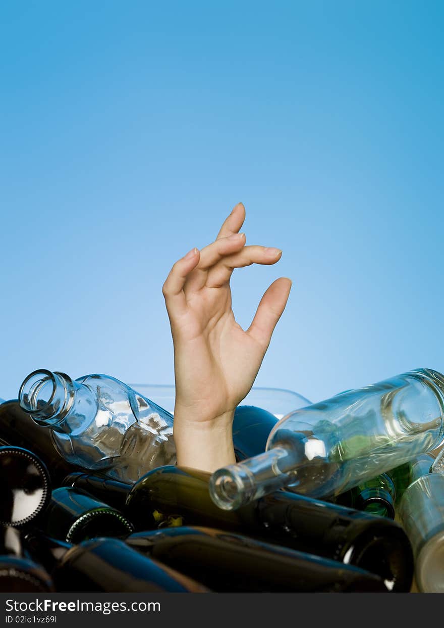 Human buried in a stack of glass bottles. Human buried in a stack of glass bottles