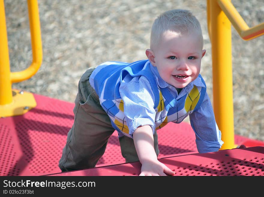 Smiling young boy playing on playground