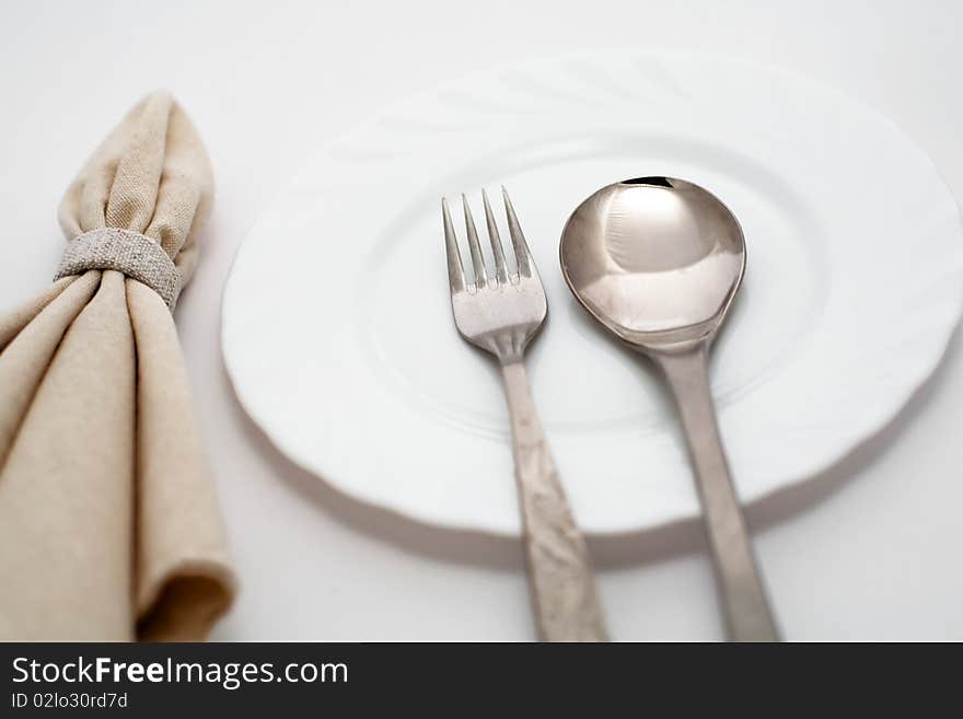 An image of fork, spoon and napkin. An image of fork, spoon and napkin