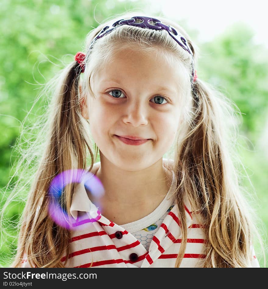 An image of a nice little girl with bubbles