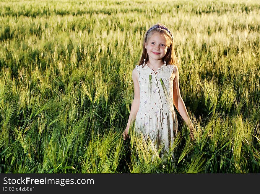 An image of a girl in the field of barley