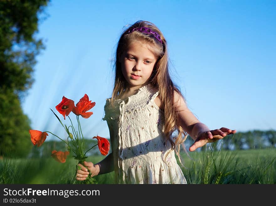 An image of a beautiful girl in the field with poppies. An image of a beautiful girl in the field with poppies