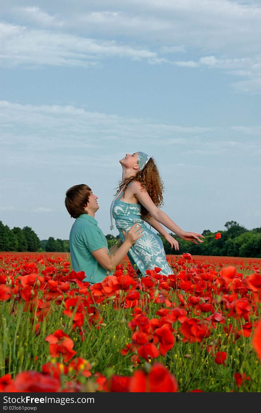 Loving couple in a field with poppies near Dnepropetrovsk .2010