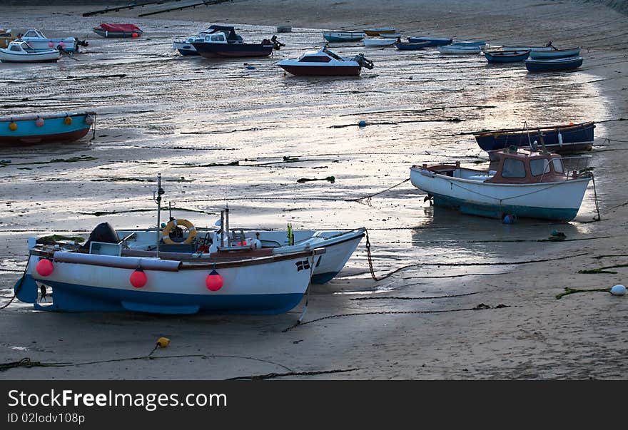 Boats and retreating tide in St Ives, early evening. Cornwall, England. Boats and retreating tide in St Ives, early evening. Cornwall, England.