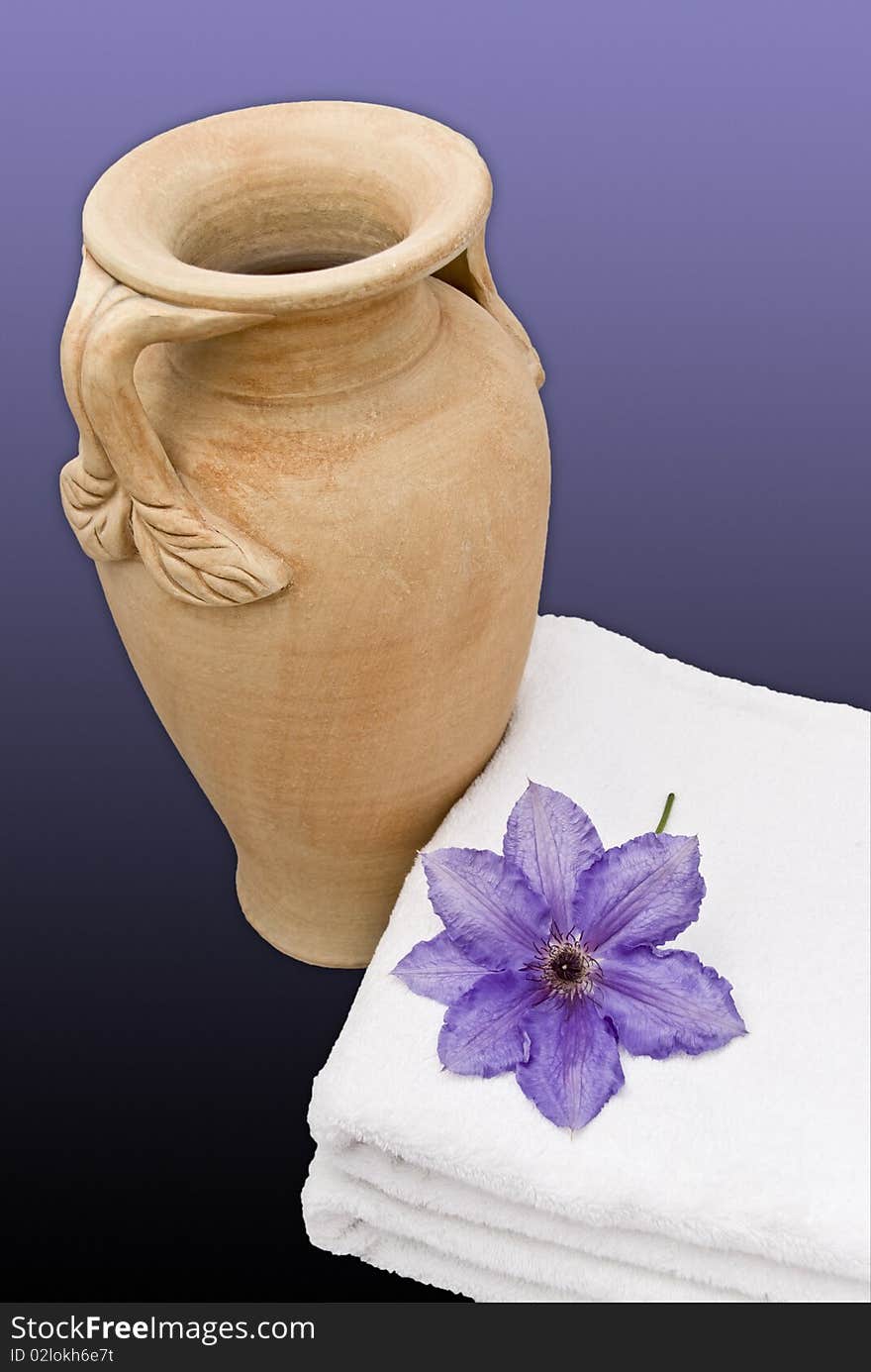 A blue clematis on a towel, with an Urn. A blue clematis on a towel, with an Urn