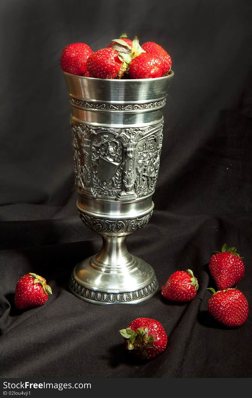 Red strawberrys with a silver cup. Red strawberrys with a silver cup