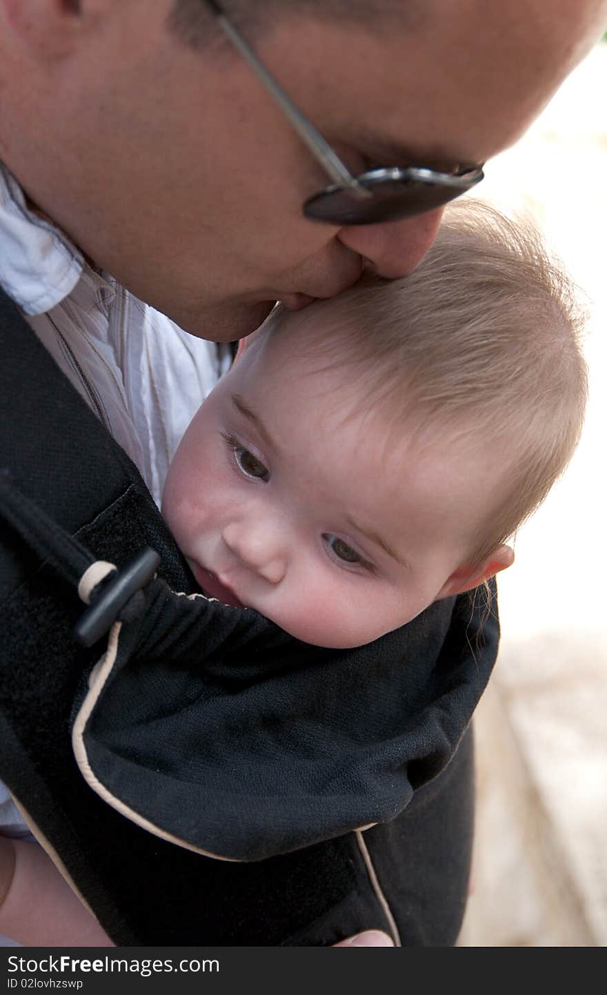 Father with a little child in a sling. Father with a little child in a sling