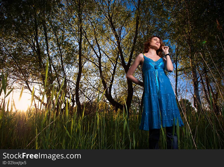 Young woman at uptown sunset reeds. Young woman at uptown sunset reeds