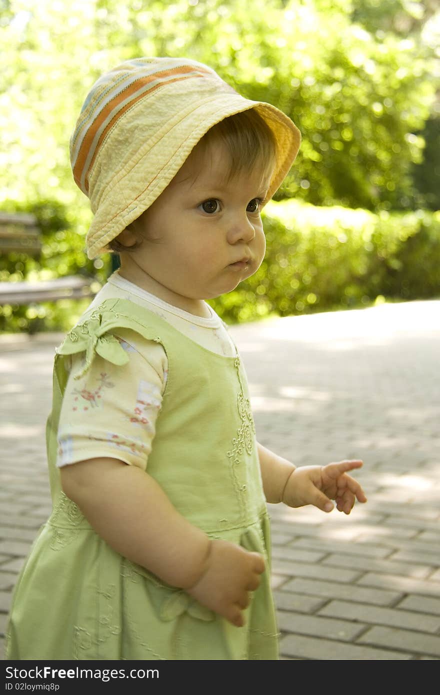 The girl on which the green dress is put on warns a finger. The girl on which the green dress is put on warns a finger