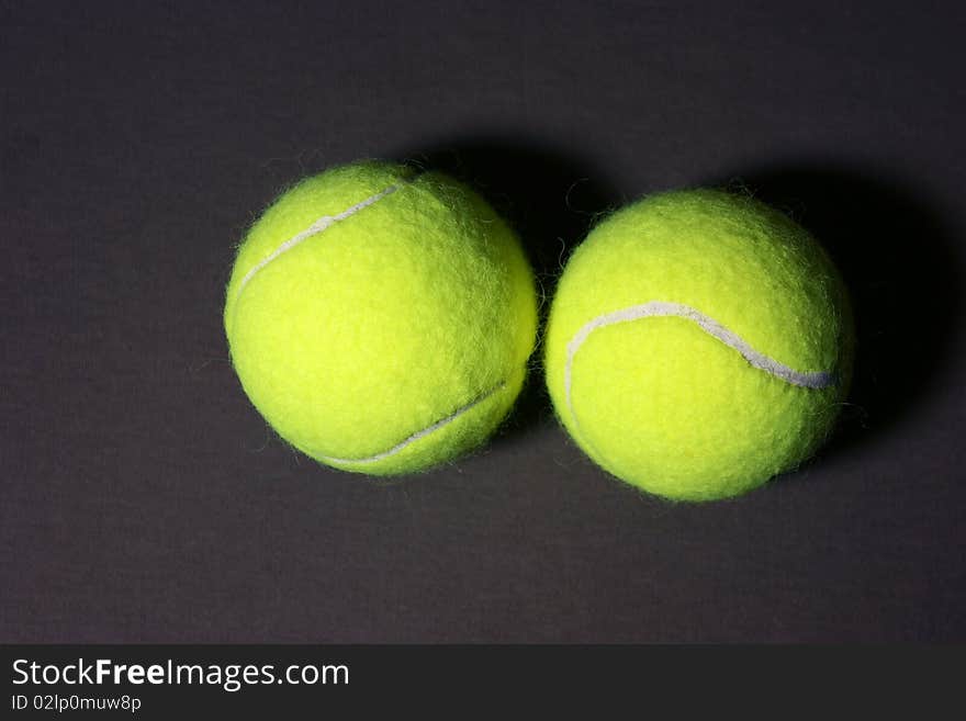 2 tennis balls on the gray background