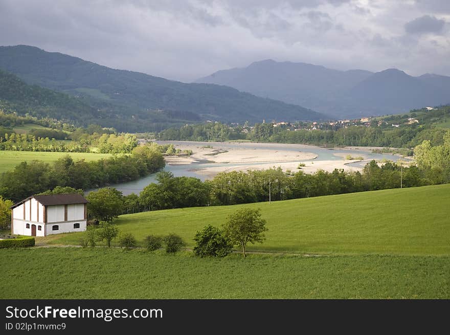 Landscape mountain. In season rains, the river full branches and the water takes a green emerald, opening in the sky cloudy allowing the sun to pass through. Landscape mountain. In season rains, the river full branches and the water takes a green emerald, opening in the sky cloudy allowing the sun to pass through