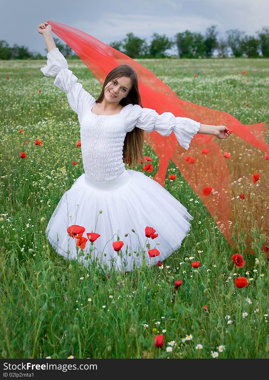 Young happy girl with red veil in field. Young happy girl with red veil in field