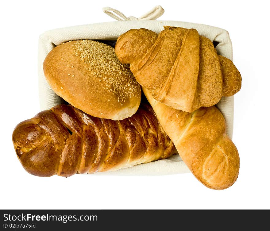 Fresh bread rolls in a basket on whitete