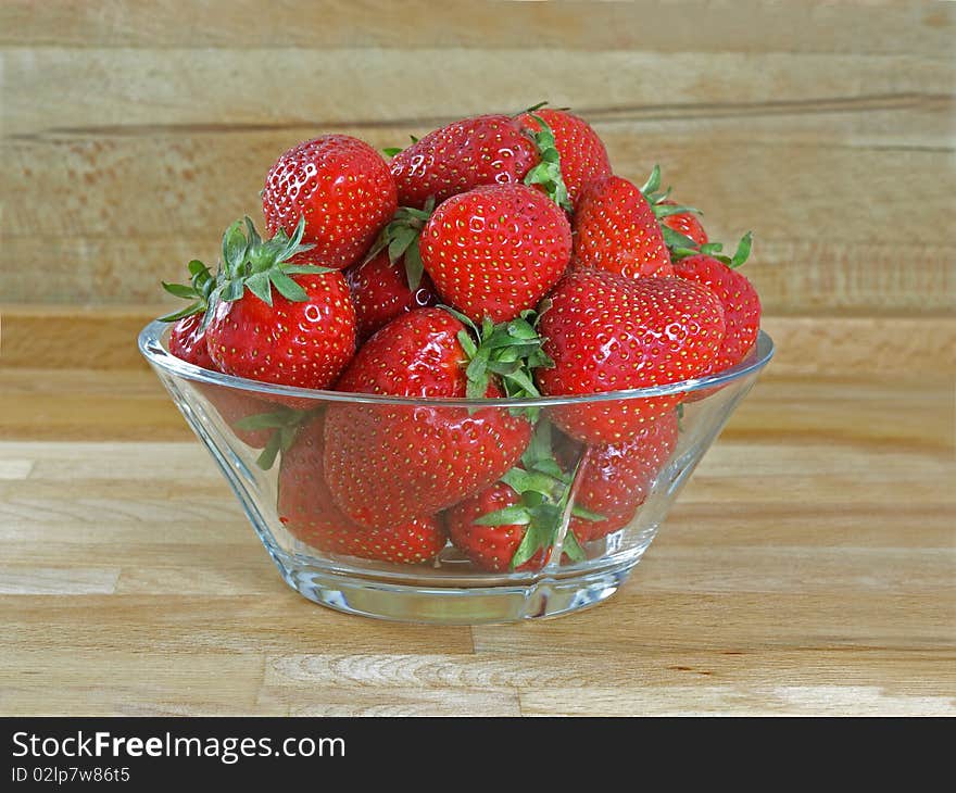 Fresh and juicy strawberries on glass bowl