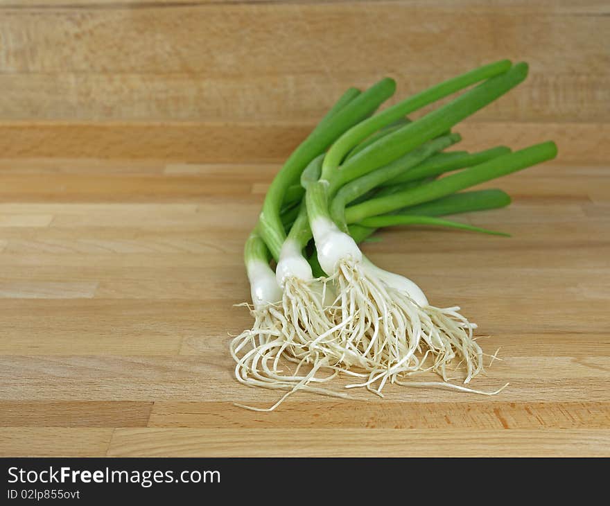 Fresh and green spring onions on cutting board. Fresh and green spring onions on cutting board