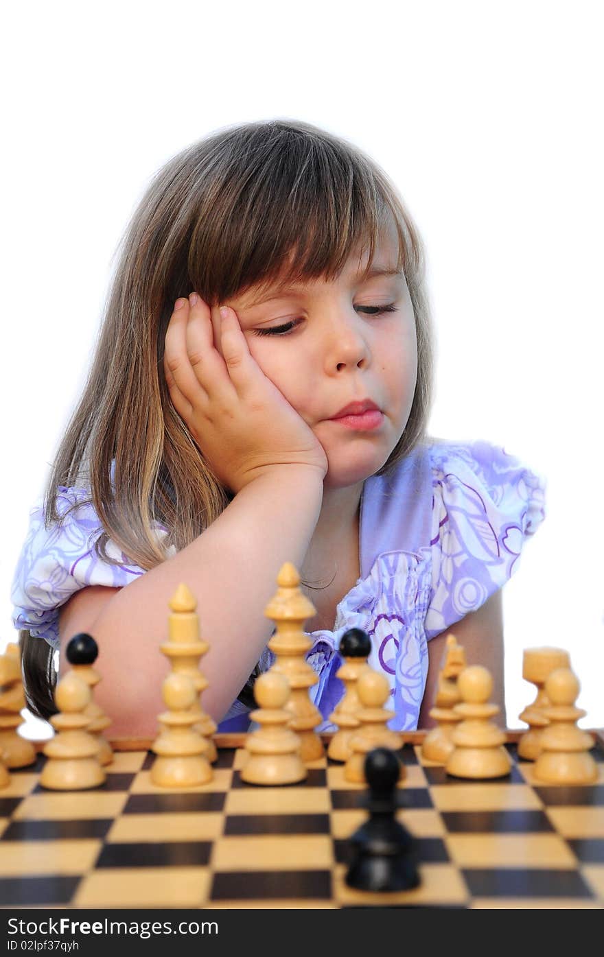 Little girls learn to play chess. Little girls learn to play chess