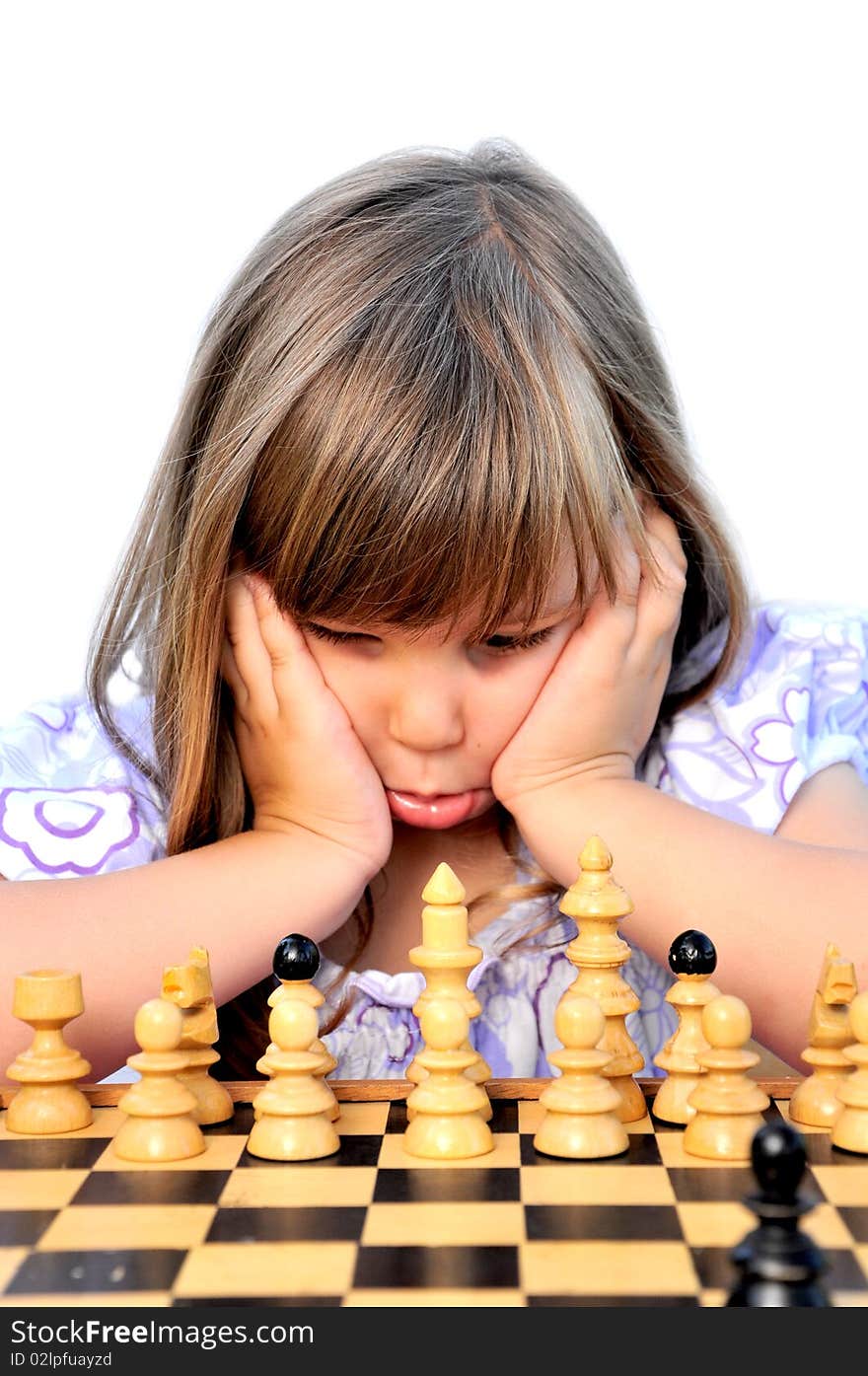 Little girls learn to play chess. Little girls learn to play chess