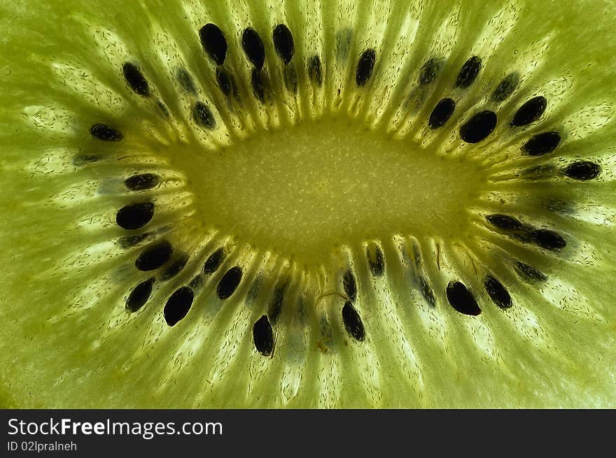 Slice of kiwi fruit close up on a light table