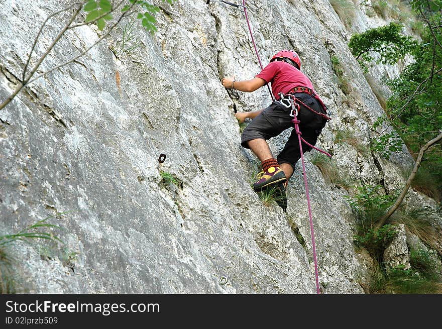 The climber try to touch the top of the route. The climber try to touch the top of the route.