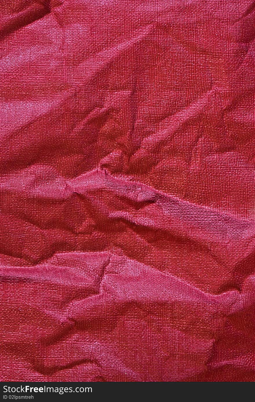 A background of red crunched up paper. A background of red crunched up paper