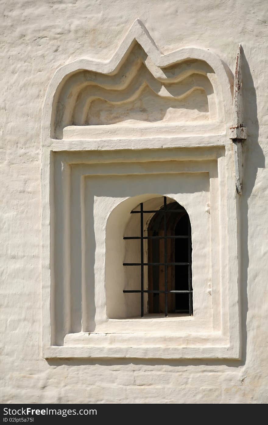 Church window in an ancient wall of the monastic house