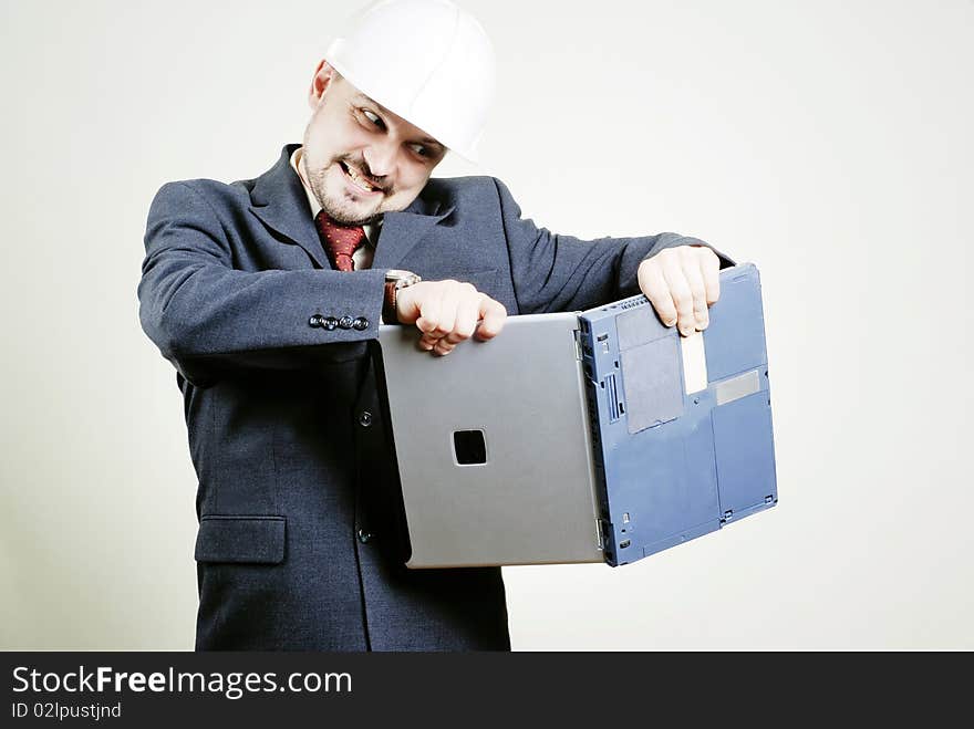 Anger businessman breaking off laptop