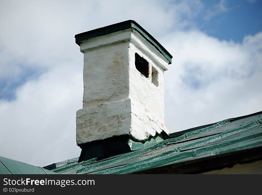 Brick elegant flue on a roof, painted with a white paint. Brick elegant flue on a roof, painted with a white paint