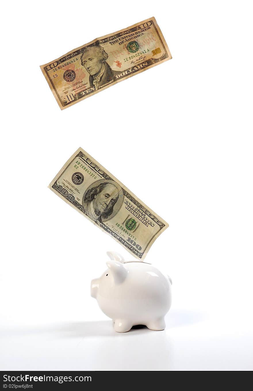 Piggy bank and falling dollars