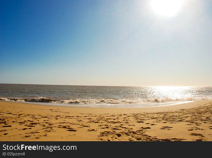 Beautiful seascape with sun, sky, ocean and sand