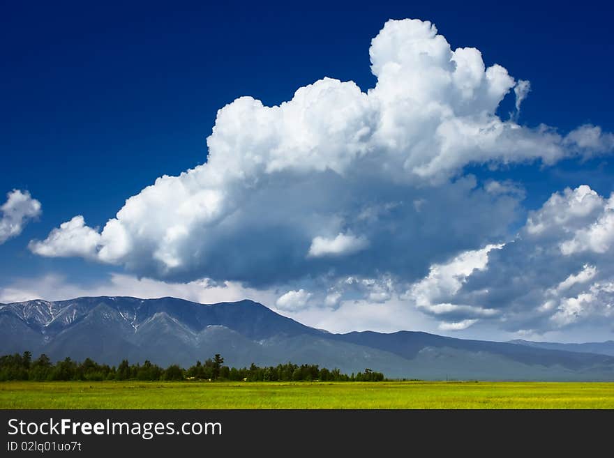 Mountains valley and blue sky with fluffy clouds