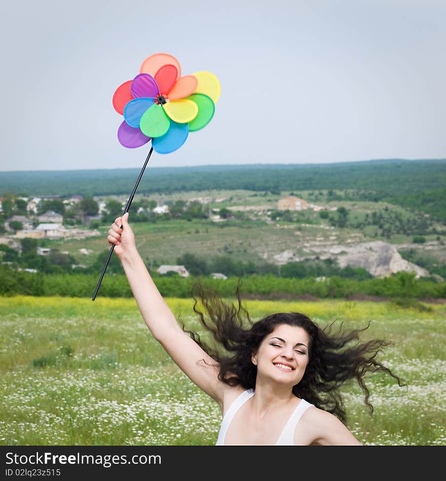 Young happy girl jumping in field with colorful flower. Young happy girl jumping in field with colorful flower