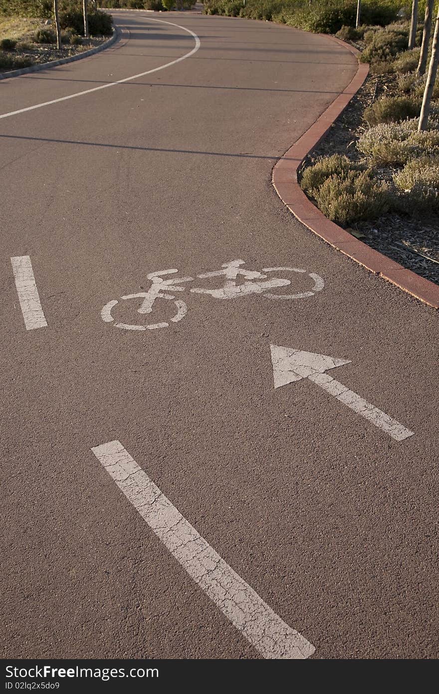 Cycle lane with bicycle symbol and arrow in the foreground. Cycle lane with bicycle symbol and arrow in the foreground