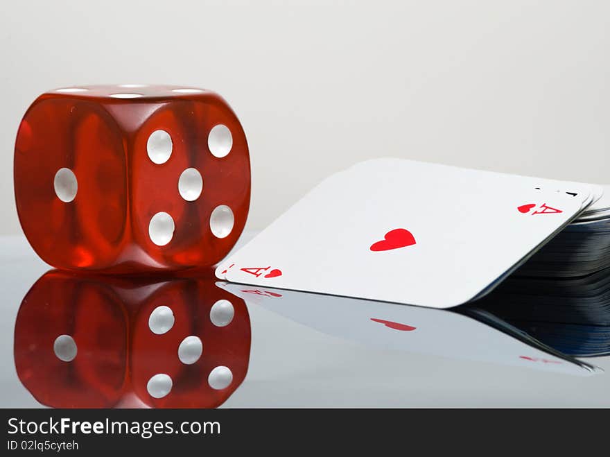 Red Dice and card deck with reflection