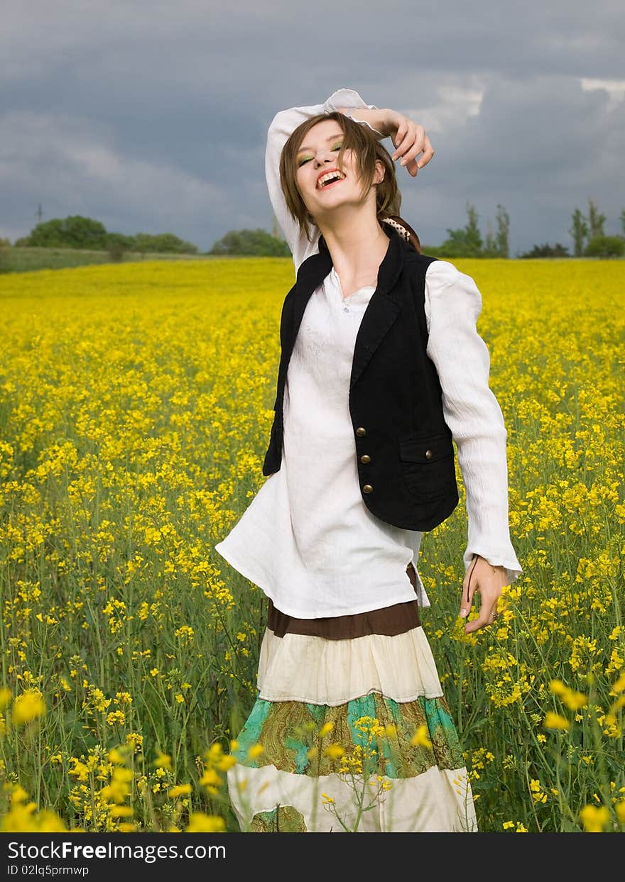 Young girl resting in rape field. Young girl resting in rape field