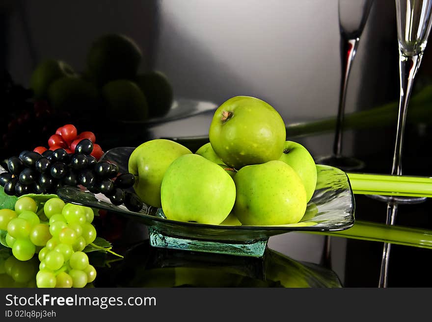 Composition with grapes and apples in dark background