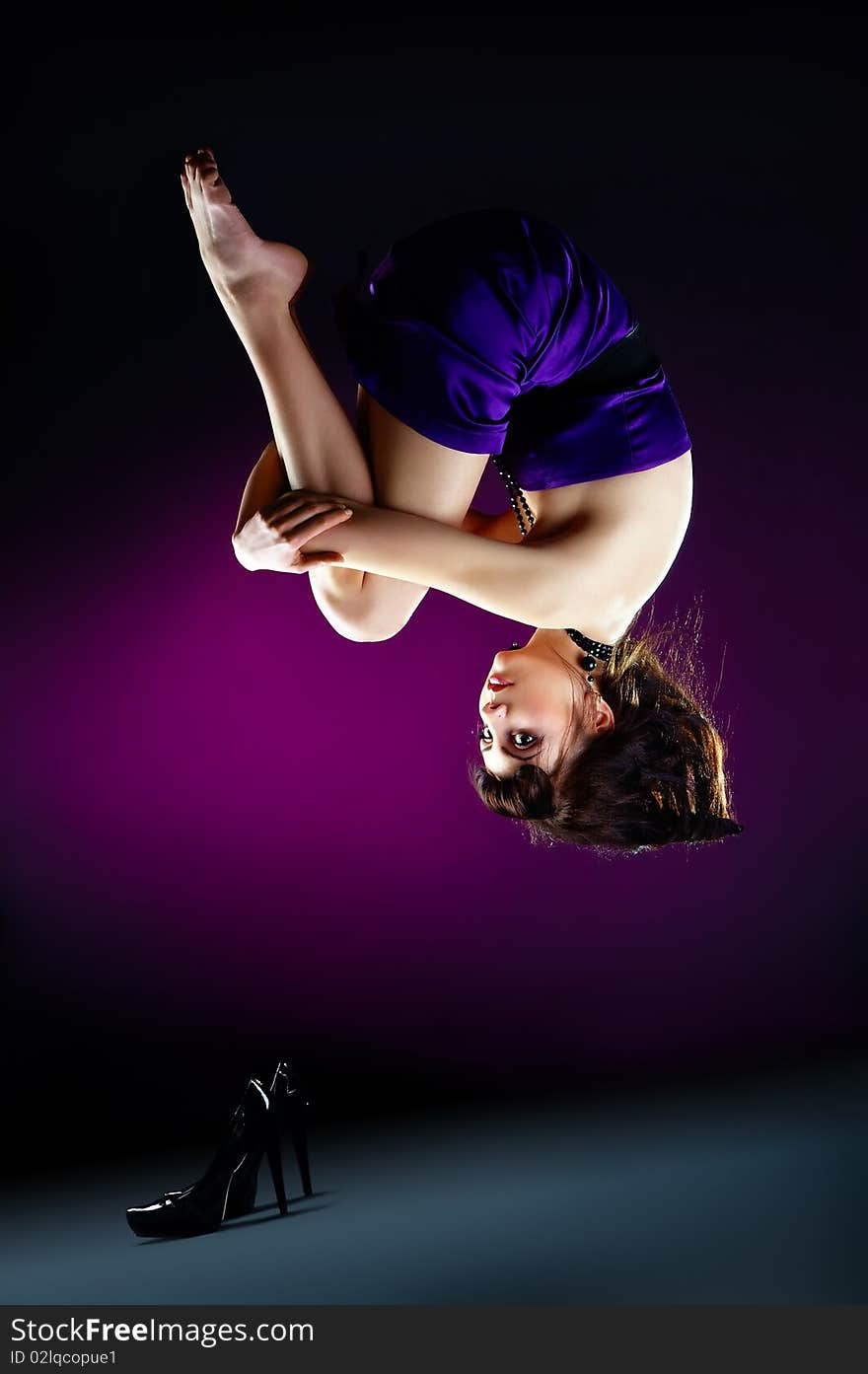 The portrait of a beautiful lady wearing a violet dress and zero gravity. The portrait of a beautiful lady wearing a violet dress and zero gravity