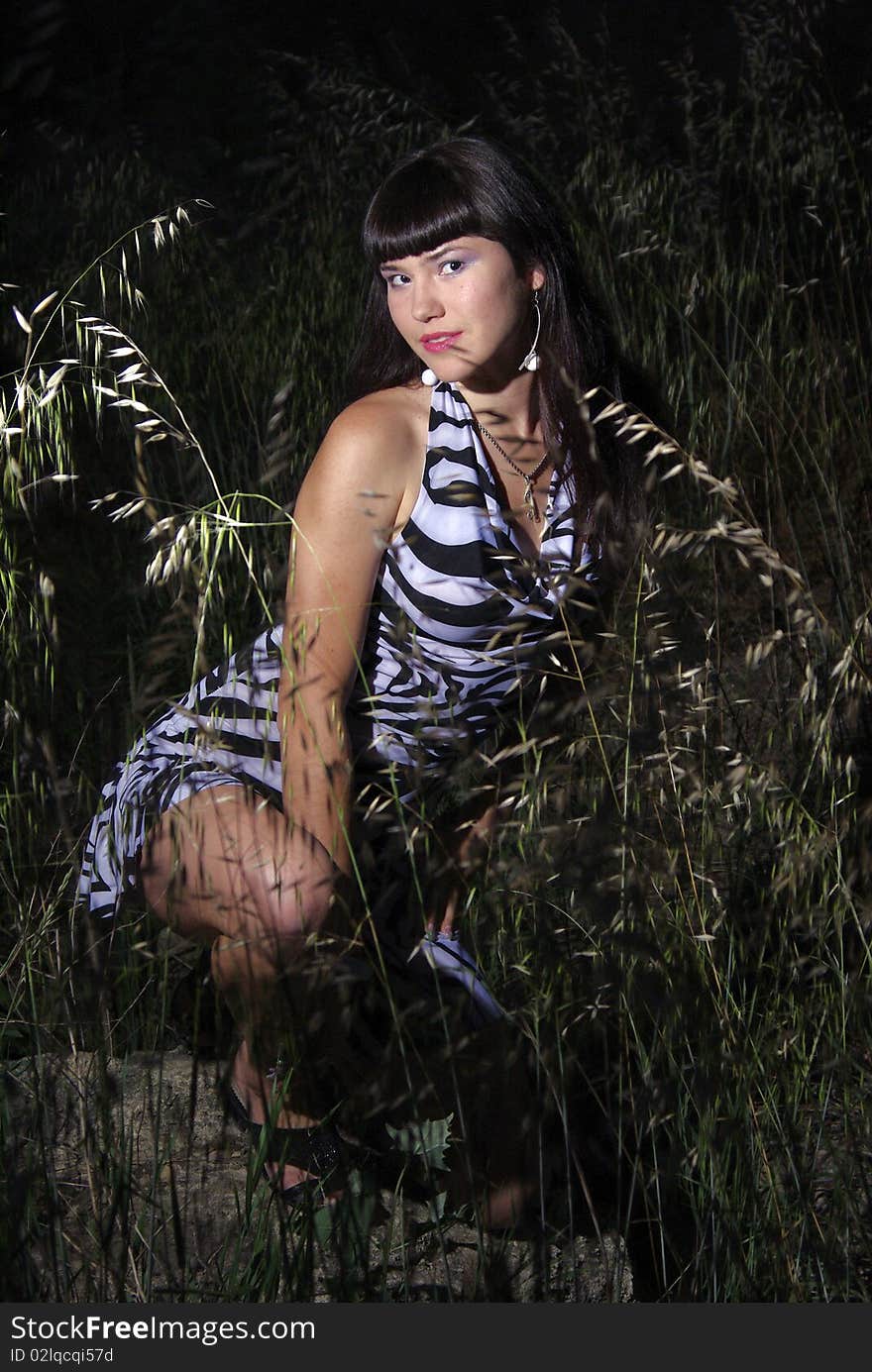 Asian lady in a grass in a night