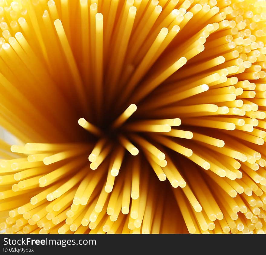 Closeup looking down the length of spaghetti noddles. Closeup looking down the length of spaghetti noddles