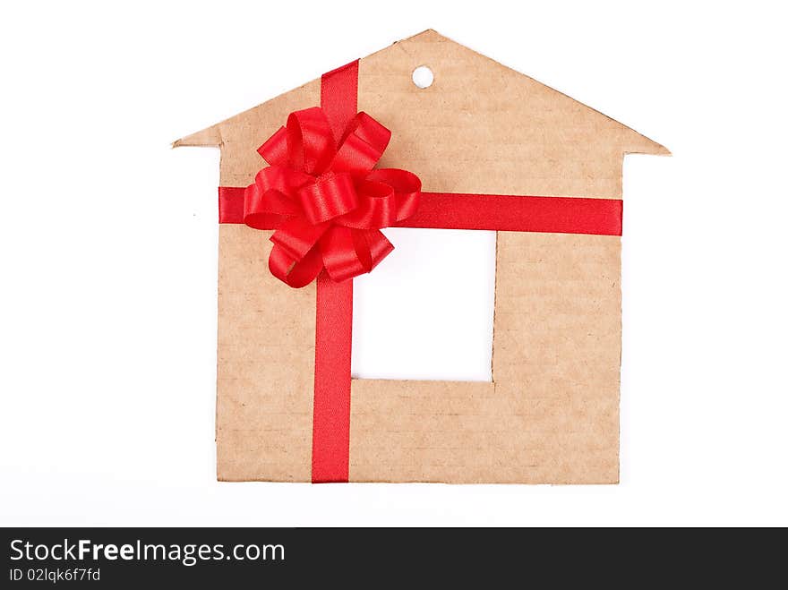 Cardboard house with red ribbon and bow