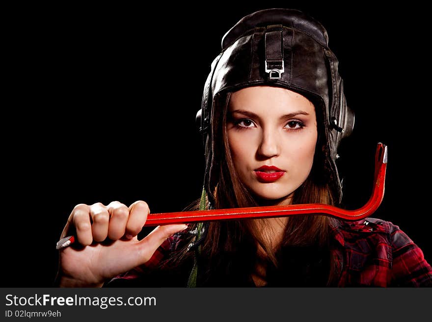 Young beautiful woman in cell shirt with red crowbar. Young beautiful woman in cell shirt with red crowbar