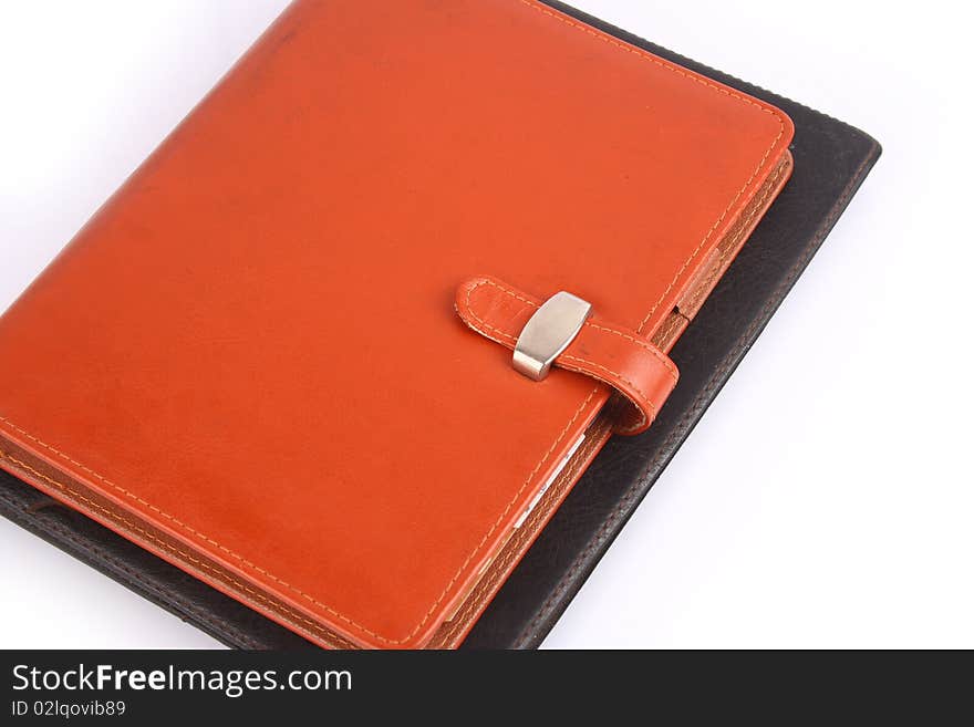 Orange leather notebook isolated on white