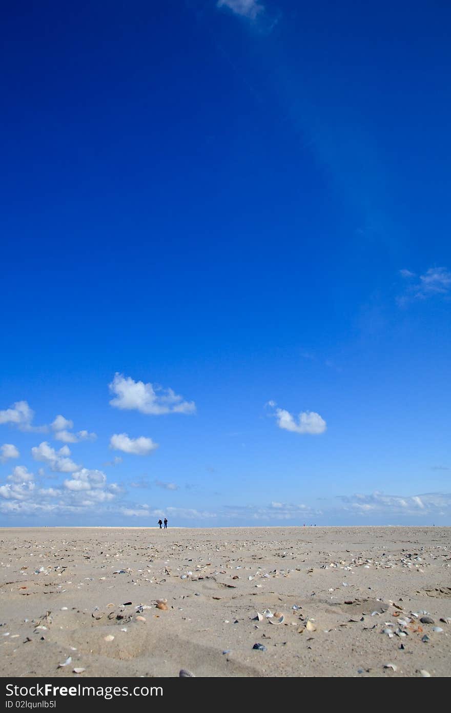 A blue clear sky with beach and ocean