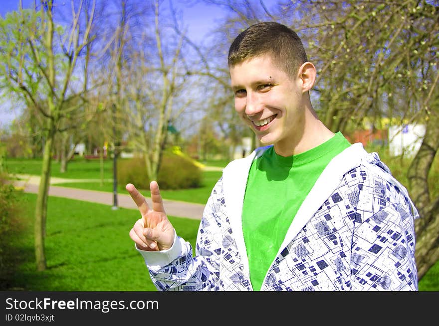 Teenager conceptual image. Teenager giving the youth sign.