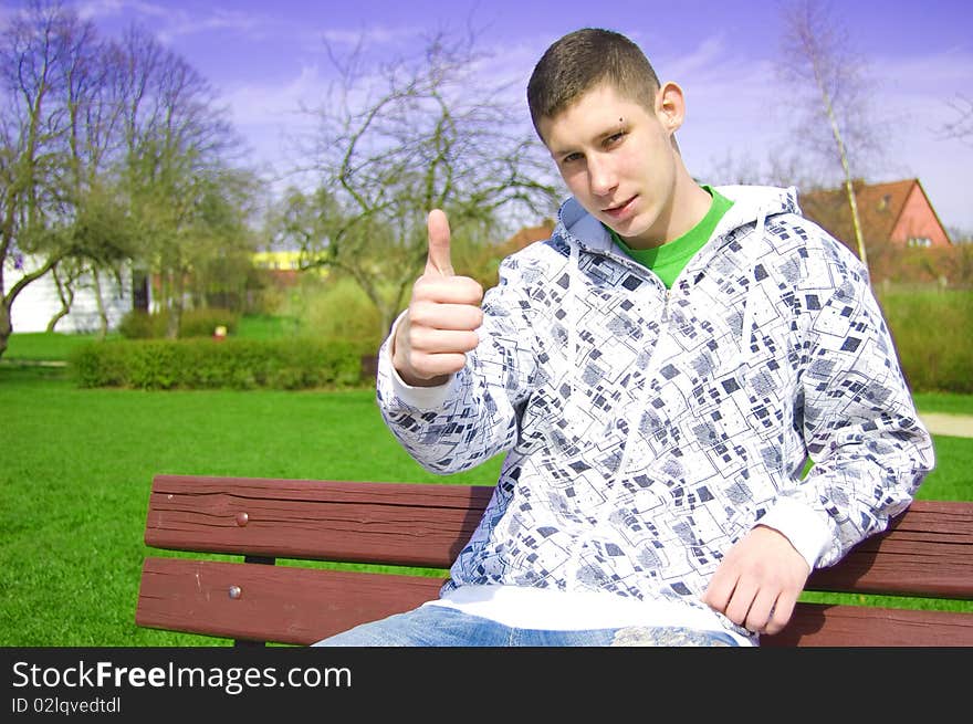 Teenager conceptual image. Teenager giving the thumbs-up sign.