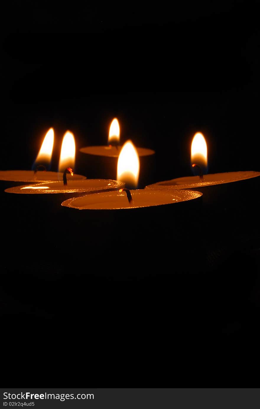 Burning candles on a dark background with warm light