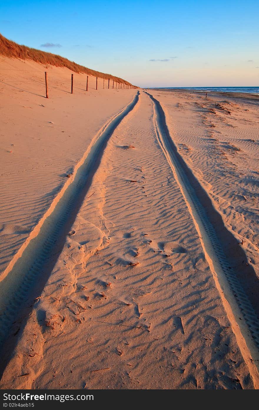 Beautiful sunset at the beach with trail of car. Beautiful sunset at the beach with trail of car