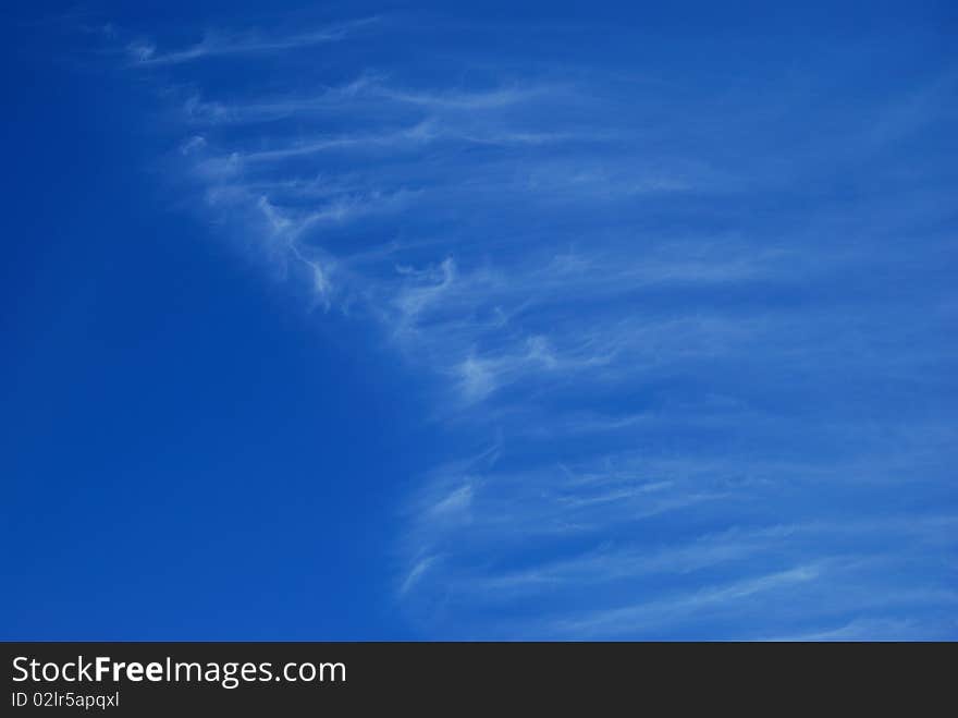 White transparent clouds against the blue sky