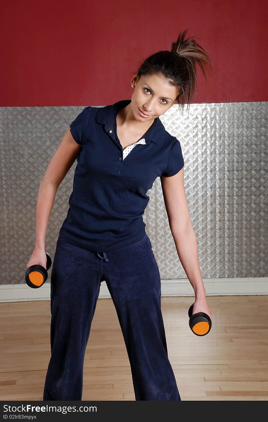 Woman Exercising With Dumbbells