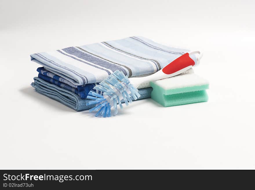 A Washing Up Brush, Scouring Pad and Three Folded Drying Cloths. A Washing Up Brush, Scouring Pad and Three Folded Drying Cloths