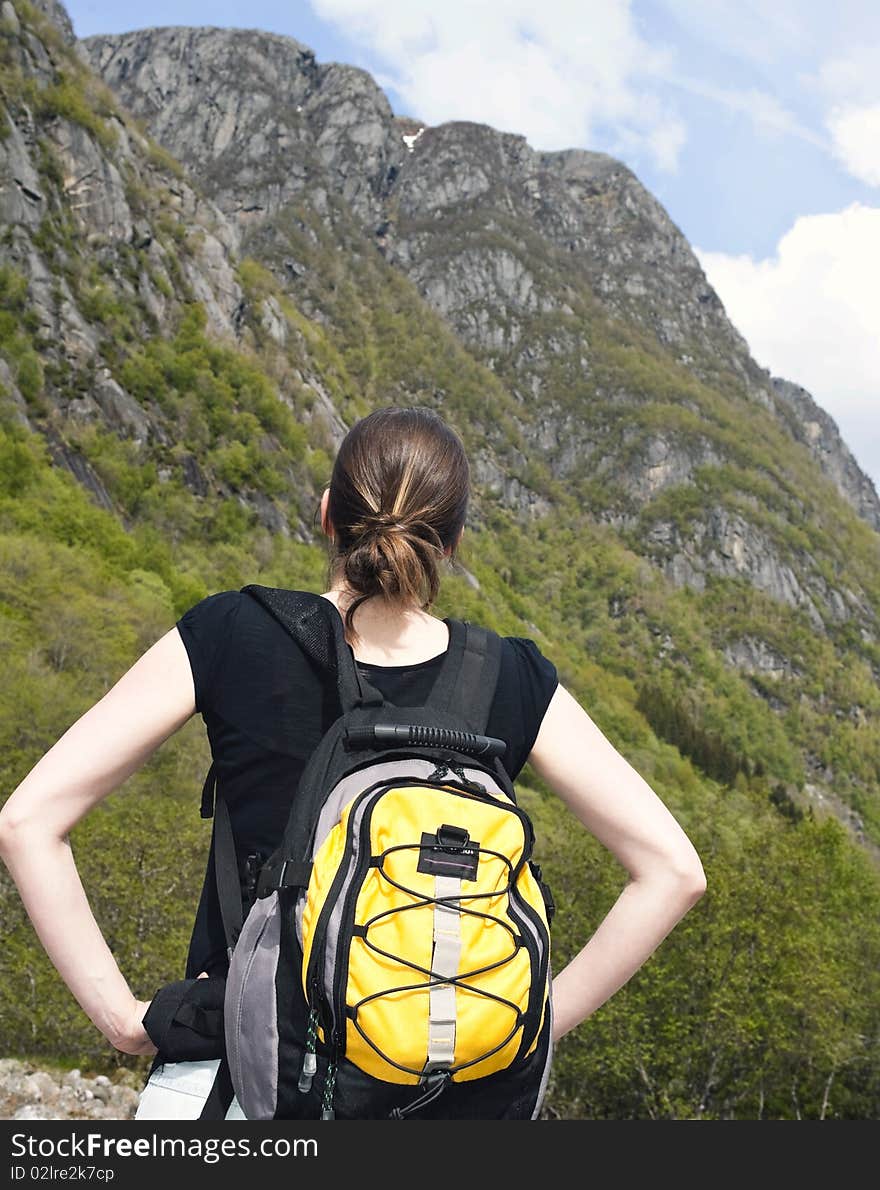 Woman hiker looks to the mountain. Woman hiker looks to the mountain